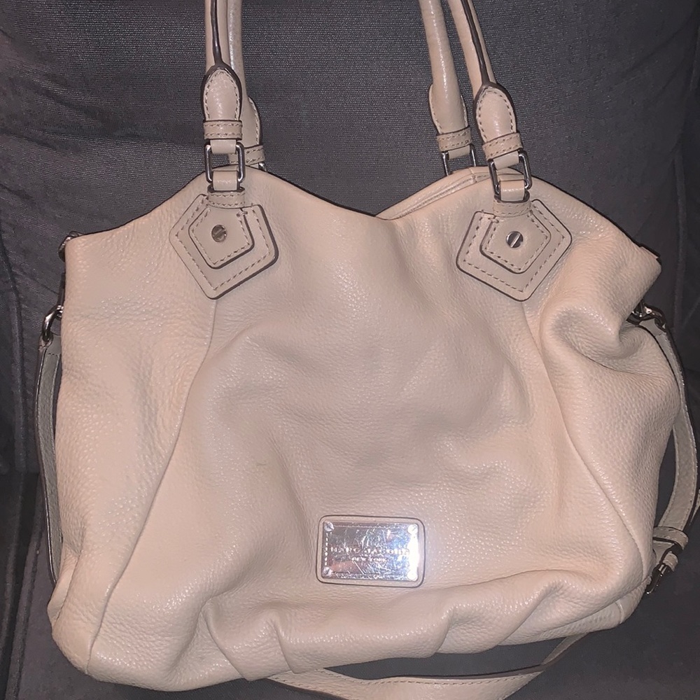 Cream Marc Jacobs hobo style bag with long crossbody strap and short handles.